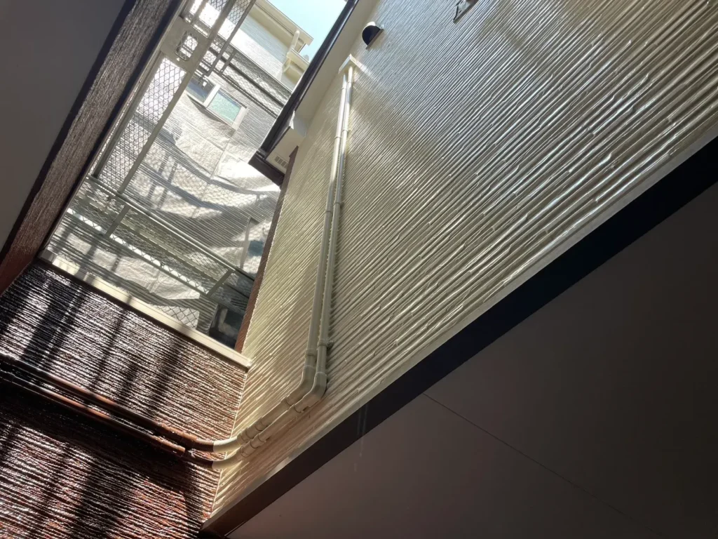 外壁と雨樋を含む付帯部塗装の施工後。上下の配色バランスが整い、新築のような外観に。